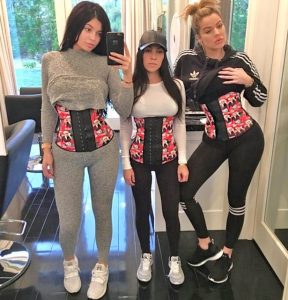 Kourtney Kardashian and her friends with corsets are taking photoes.