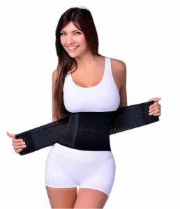 Smiling woman holds waist training.