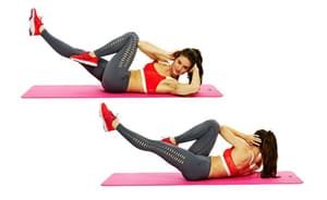 Woman showing twist crunches on the ground