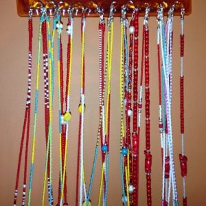 Colorful waist beads on the wall.