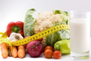 Various foods and a soft rule on the table.