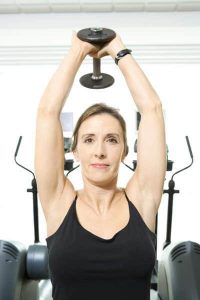 Woman is doing dumbbell pullovers.