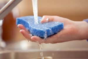 Washing sponge in kitchen