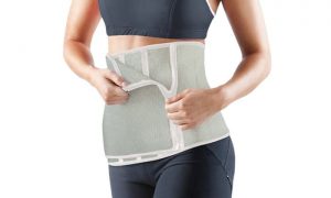 Woman is wearing waist trimmer belt.