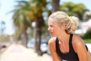 Tired running woman taking a break during run