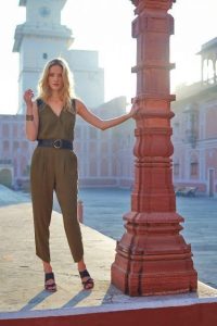 Corset belt over an olive jumpsuit