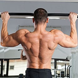 Man doing pull up to work out his lats