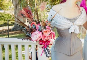 Woman wearing a stealth corseting holding flower 